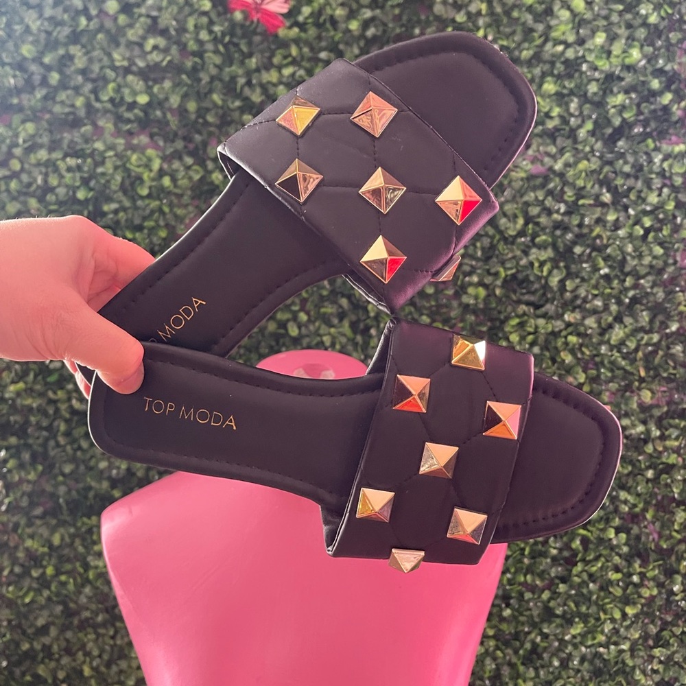 Gold studded black slides
